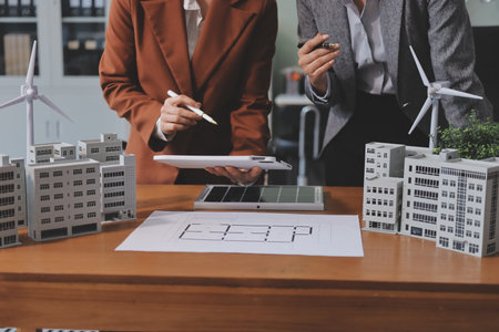 Discussion among businesspeople on the latest developments in solar cell panel technology and Solar Energy Environment city Concept.の写真素材