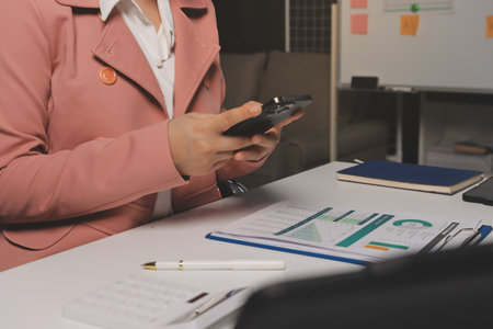 Cropped image of professional businesswoman working at her office via laptop, young female manager using portable computer device while sitting at modern loft, work process conceptの写真素材