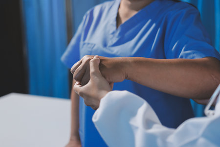 Orthopedist examining patient in hospitalの写真素材