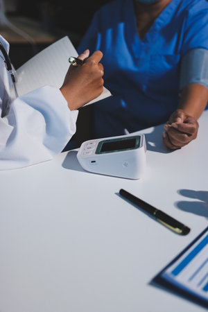 Doctor checking blood pressure to a patient in the hospital.の写真素材