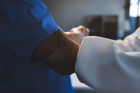 Orthopedist examining patient in hospitalの写真素材