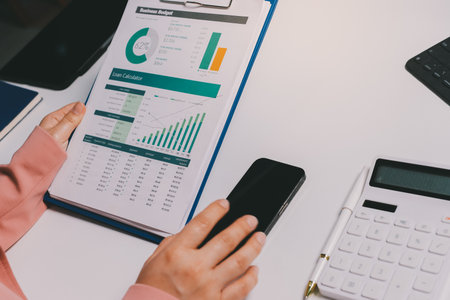 Cropped image of professional businesswoman working at her office via laptop, young female manager using portable computer device while sitting at modern loft, work process conceptの写真素材