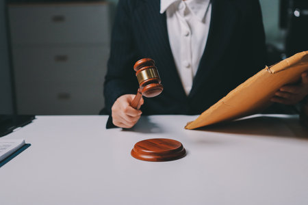 Judge gavel with Justice lawyers having team meeting at law firm background. Concepts of Law and Legal services.の写真素材