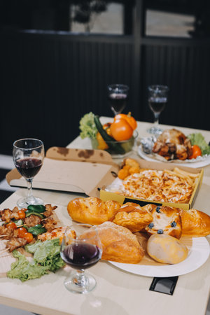 Asian office colleagues and friends enjoy a daytime BBQ with pizza, celebrating Halloween and cheering for their favorite soccer team, creating a lively atmosphere filled with joy.の写真素材