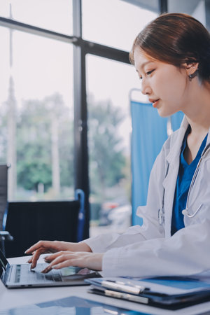 Medical health clinic doctor working using smart tablet touching, stethoscope diagnosing patient analysis research examination healthcare provider service insurance in modern officeの写真素材