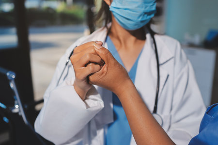 Orthopedist examining patient in hospitalの写真素材