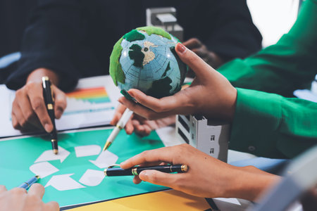 Young Asian business team discussion reusable product in office,start up eco-friendly business,environmental protection,sustainable business model,ESG strategy,team meeting,people work at home conceptの写真素材