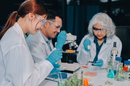 Team Asian scientists in a lab conducting food research using a microscope and lab equipment, showcasing innovation in food science and biotechnologyの写真素材