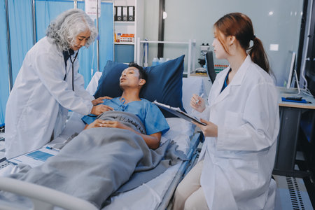 Nurse giving assistance to senior patient with disease in bed. Medical assistant and doctor doing healthcare checkup for pensioner with oxygen tube and IV drip bag in hospital ward.の写真素材