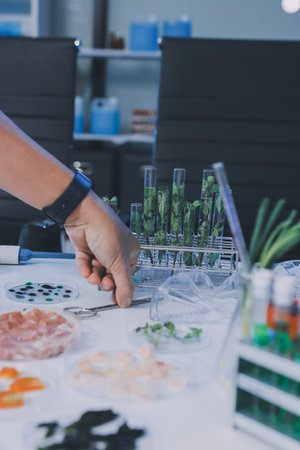Team Asian scientists in a lab conducting food research using a microscope and lab equipment, showcasing innovation in food science and biotechnologyの写真素材