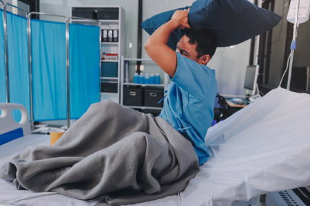 Lonely man silhouette sitting on the bed feeling depressed and stressed in the dark bedroomの写真素材