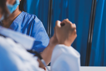 Orthopedist examining patient in hospitalの写真素材