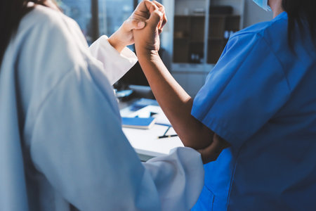 Orthopedist examining patient in hospitalの写真素材