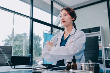 Medical health clinic doctor working using smart tablet touching, stethoscope diagnosing patient analysis research examination healthcare provider service in modern officeの写真素材