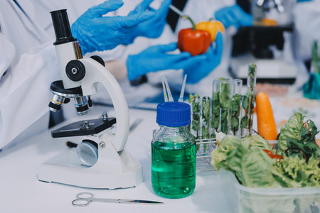 Team Asian scientists in a lab conducting food research using a microscope and lab equipment, showcasing innovation in food science and biotechnologyの写真素材