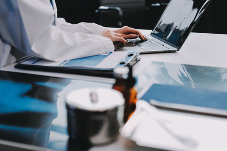 Medical health clinic beautiful Asian doctor working using smart tablet touching, stethoscope diagnosing patient analysis research examination healthcare provider service insurance in modern officeの写真素材