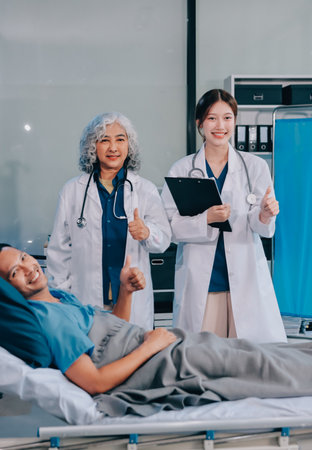 Nurse giving assistance to senior patient with disease in bed. Medical assistant and doctor doing healthcare checkup for pensioner with oxygen tube and IV drip bag in hospital ward.の写真素材