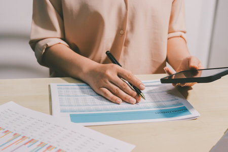 Tax deduction planning concept. Women use a calculator to calculate expenses and taxes to receive tax deductions for personal individual Income. tax return for individual persons.monthly expensesの写真素材