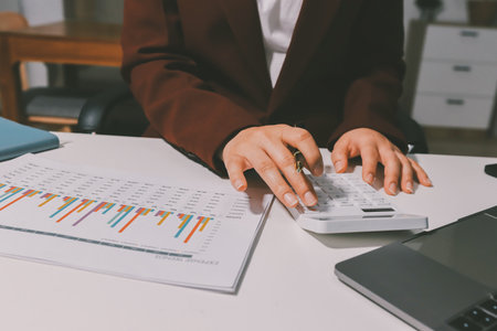 Tax deduction planning concept. Women use a calculator to calculate expenses and taxes to receive tax deductions for personal individual Income. tax return for individual persons.monthly expensesの写真素材