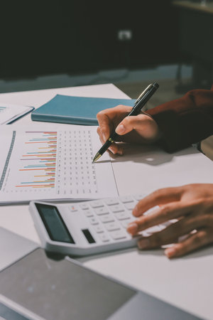 Tax deduction planning concept. Women use a calculator to calculate expenses and taxes to receive tax deductions for personal individual Income. tax return for individual persons.monthly expensesの写真素材