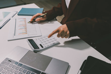Tax deduction planning concept. Women use a calculator to calculate expenses and taxes to receive tax deductions for personal individual Income. tax return for individual persons.monthly expensesの写真素材