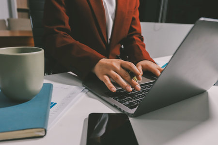 Tax deduction planning concept. Women use a calculator to calculate expenses and taxes to receive tax deductions for personal individual Income. tax return for individual persons.monthly expensesの写真素材