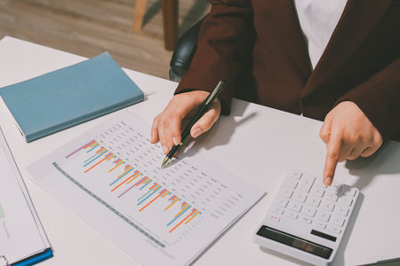Tax deduction planning concept. Women use a calculator to calculate expenses and taxes to receive tax deductions for personal individual Income. tax return for individual persons.monthly expensesの写真素材