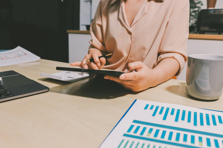 Tax deduction planning concept. Women use a calculator to calculate expenses and taxes to receive tax deductions for personal individual Income. tax return for individual persons.monthly expensesの写真素材