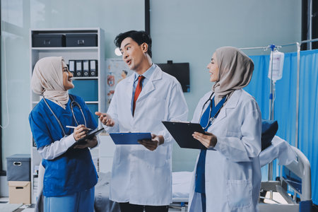 Male and female doctors are having a meeting in a hospital room.の写真素材