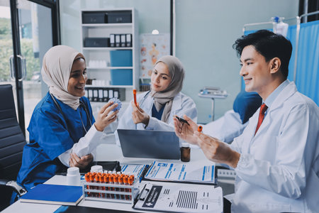 Male and female doctors are having a meeting in a hospital room.の写真素材
