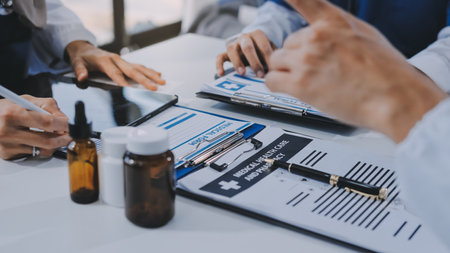Male and female doctors are having a meeting in a hospital room.の写真素材