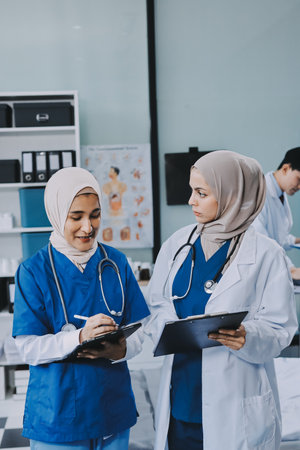 Male and female doctors are having a meeting in a hospital room.の写真素材