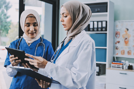 Male and female doctors are having a meeting in a hospital room.の写真素材