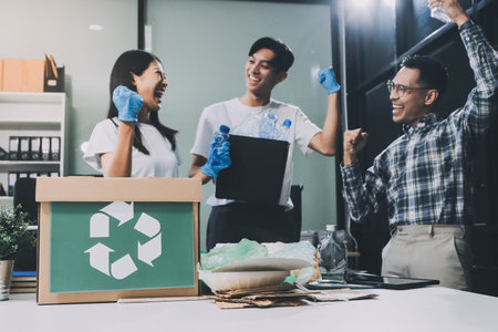 Close-up of female hands from a family collecting plastic waste and bottles from the ground. They wear gloves and focus on recycling to help reduce plastic pollution and protect the environment.の写真素材