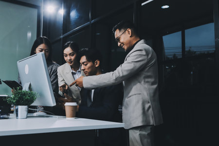 Cheerful meeting room, businesspeople celebrate with handshaking. Successful project was completed before the deadline. Business partnership and collaboration in project management.の写真素材