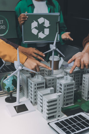 Asian business people team brainstorm meeting in green corporate office. Presentation ESG project planning. Environmental conservation, responsible business, sustainable development goal conceptの写真素材