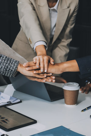 Business team showing unity with their hands together, Close up top view of young business people...