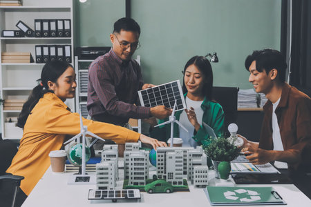 Asian business people team brainstorm meeting in green corporate office. Presentation ESG project planning. Environmental conservation, responsible business, sustainable development goal conceptの写真素材