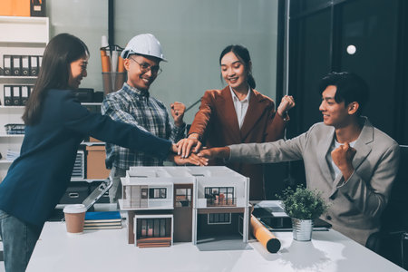 Construction, planning and architects meeting about design of building, strategy and working in industrial collaboration. Architecture workers talking about maintenance project with paper and a modelの写真素材