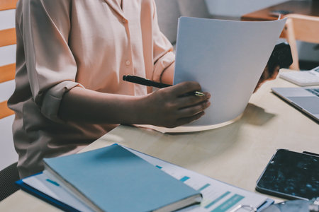 Tax deduction planning concept. Women use a calculator to calculate expenses and taxes to receive tax deductions for personal individual Income. tax return for individual persons.monthly expensesの写真素材