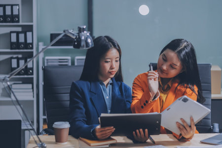 Businesswoman or accountant working Financial investment on calculator, calculate, analyze business and marketing growth on financial document data graph, Accounting, Economic, commercial concept.の写真素材