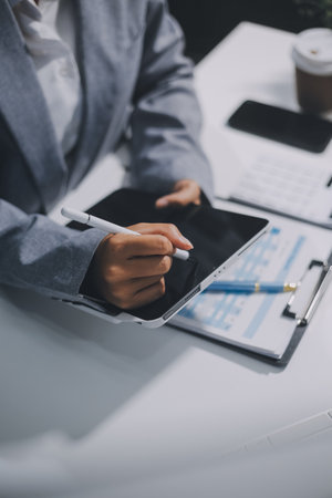 Portrait of Asian young female working on laptop at officeの写真素材