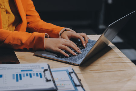 Businesswoman or accountant working Financial investment on calculator, calculate, analyze business and marketing growth on financial document data graph, Accounting, Economic, commercial concept.の写真素材