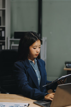 Portrait of Asian young female working on laptop at officeの写真素材