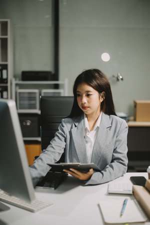 Portrait of Asian young female working on laptop at officeの写真素材