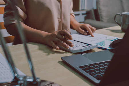 Tax deduction planning concept. Women use a calculator to calculate expenses and taxes to receive tax deductions for personal individual Income. tax return for individual persons.monthly expensesの写真素材