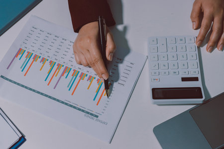 Tax deduction planning concept. Women use a calculator to calculate expenses and taxes to receive...
