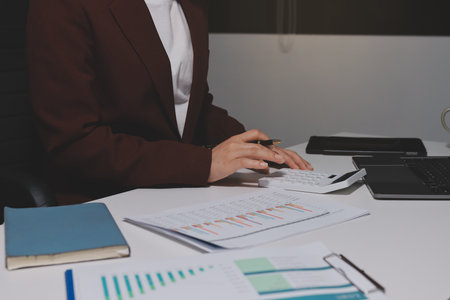 Tax deduction planning concept. Women use a calculator to calculate expenses and taxes to receive tax deductions for personal individual Income. tax return for individual persons.monthly expensesの写真素材