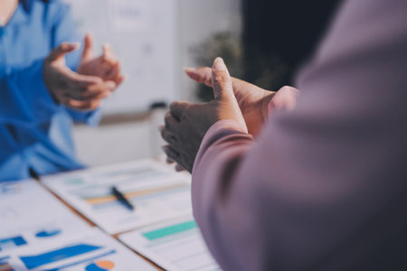 Team of businesspeople clapping hands while having a conference. Professionals applauding at a seminar.の写真素材