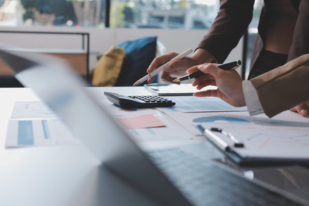 Accounting company provide finance and taxation planning for profitable cash flow, Auditor and accountant team working in office, analyze financial data and accounting record with calculator.Insightの写真素材